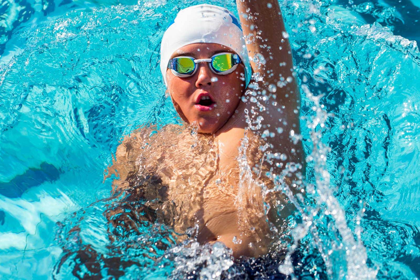 Child swimming backstroke